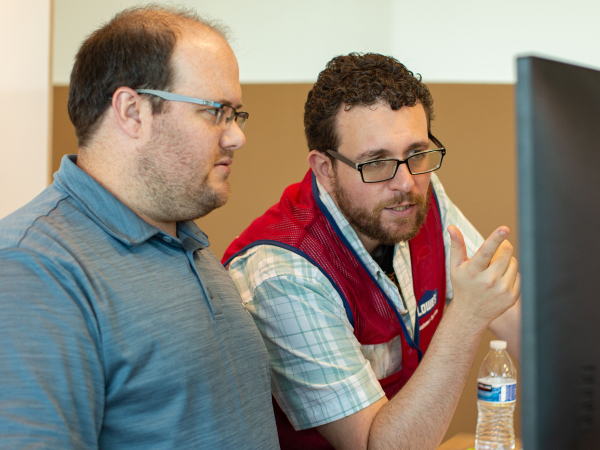 Tech trainer assisting a colleague