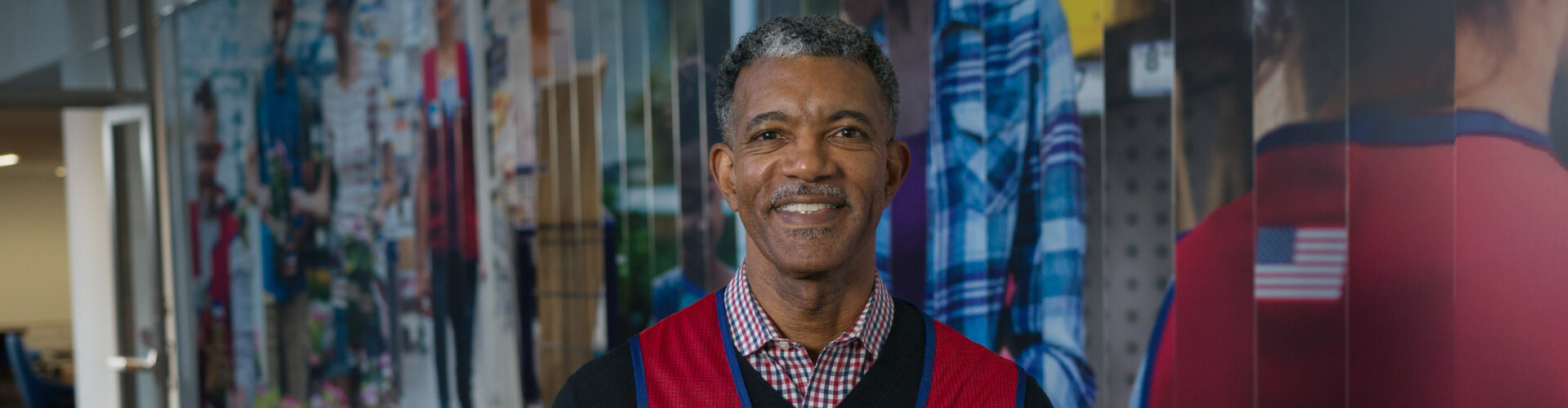 Corporate associate standing in front of a mural at corporate headquarters