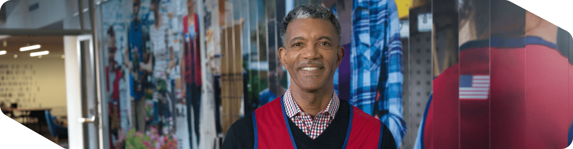 Corporate associate standing in the hallway of a Lowe's collage at headquarters