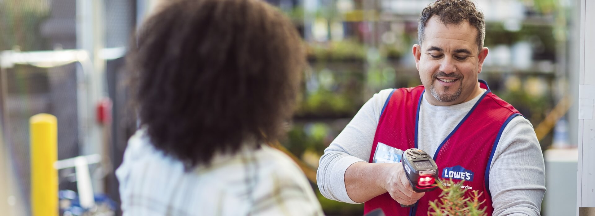 Cashier scanning a plant