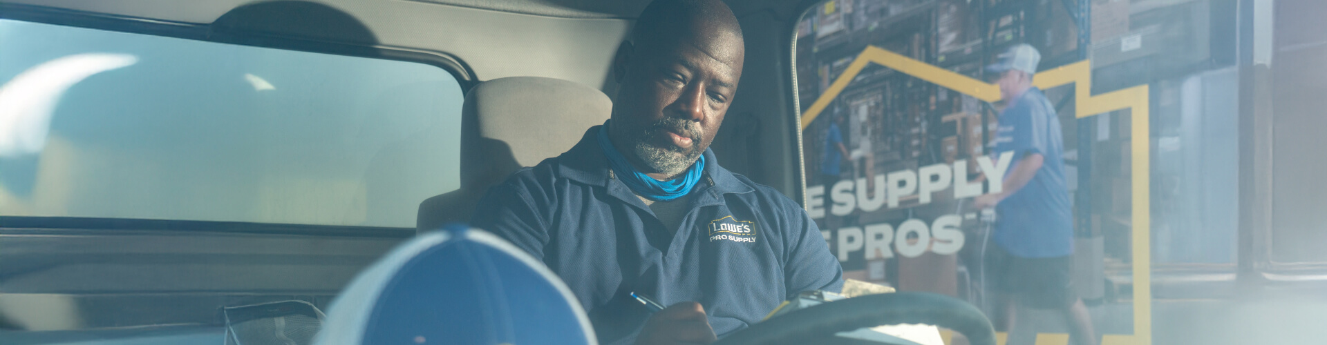 Lowe's Pro Supply Driver working in his vehicle
