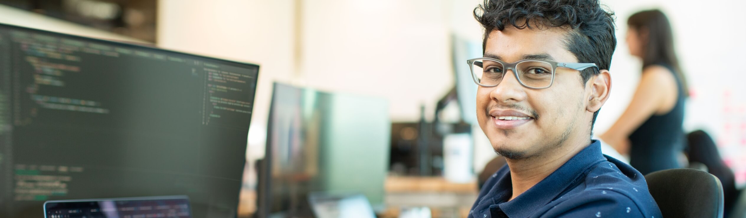 Young diverse male associate working in the Tech Hub