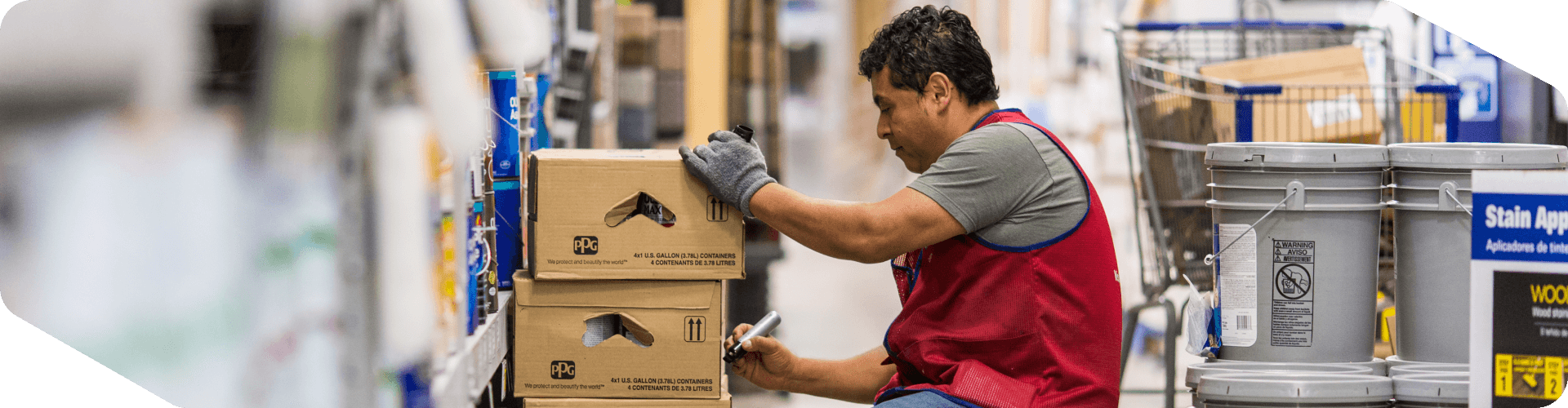 Lowe's associate stocking the paint shelves