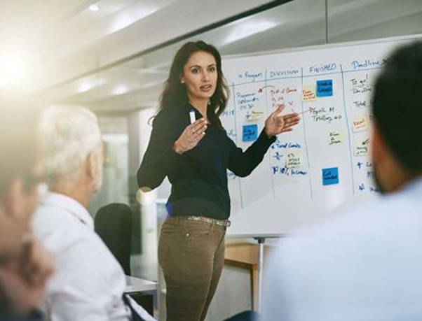 A woman presenting to a group of people