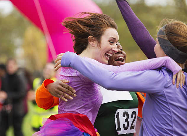 An image of Mars associates embracing in a group hug post-race.