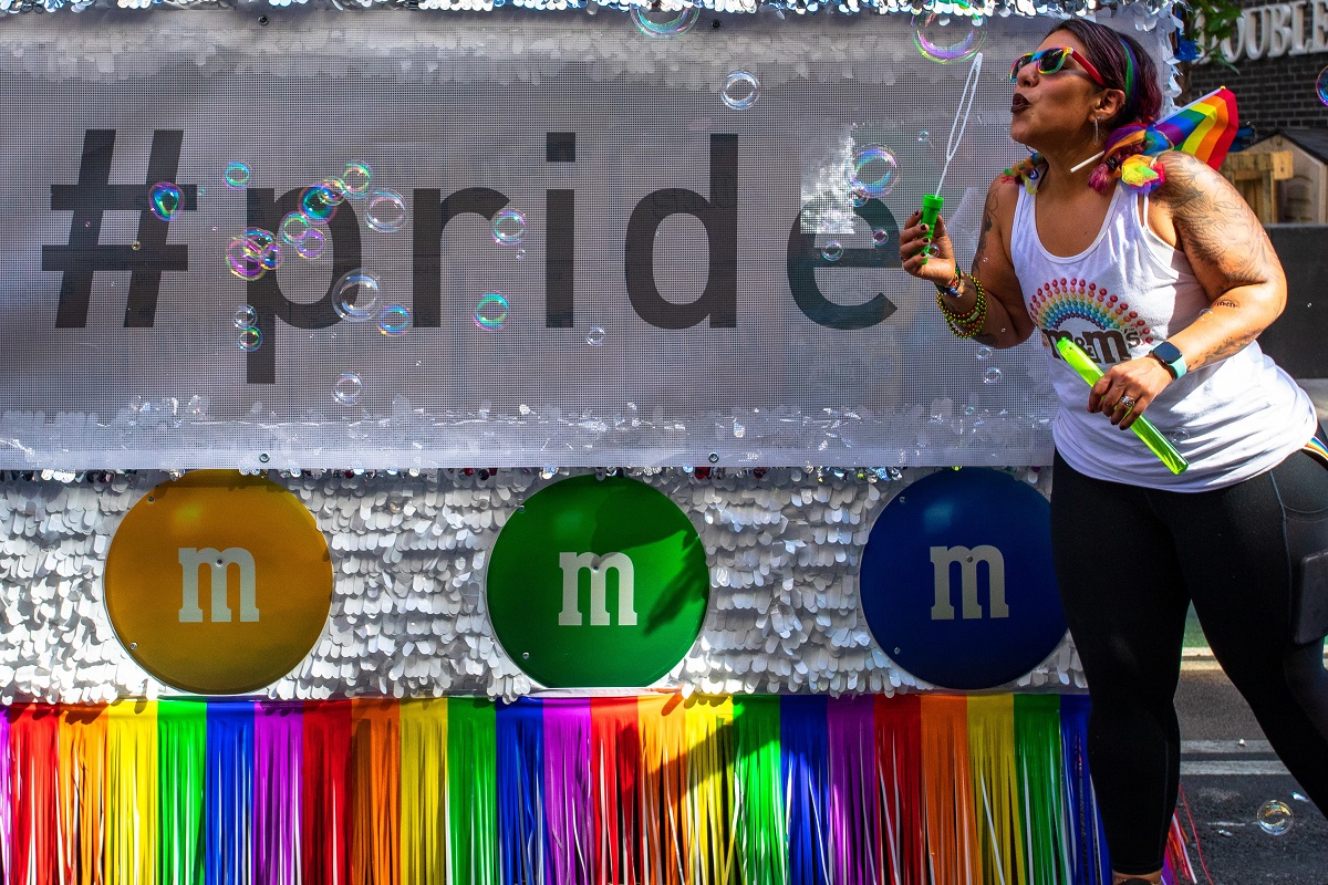 A image of a Mars Associate blowing bubbles at the pride event