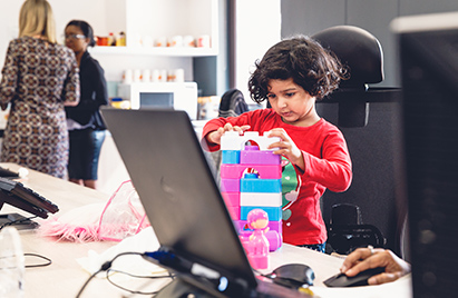 A image of a child building toy blocks at a desk