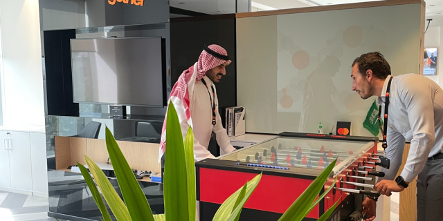 Games rom in Mastercard Riyadh office with two colleagues playing with foosball table