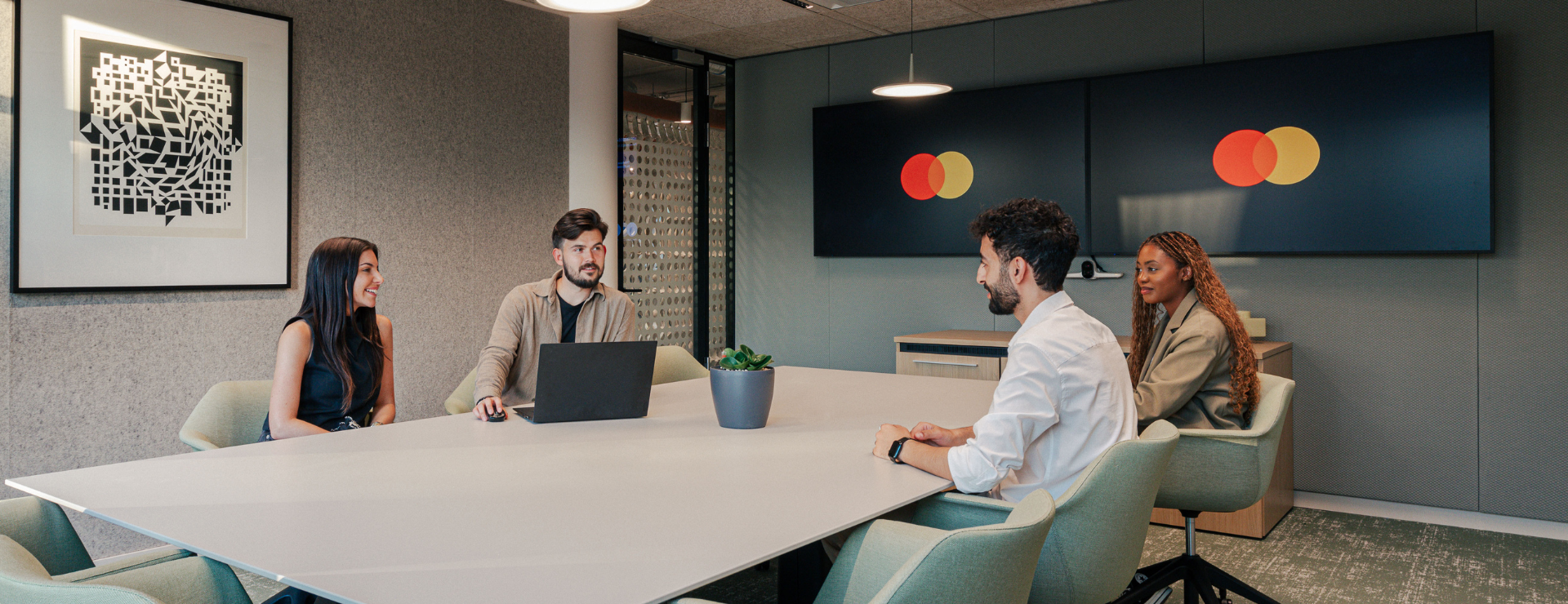 group of employees sitting and talking at a table