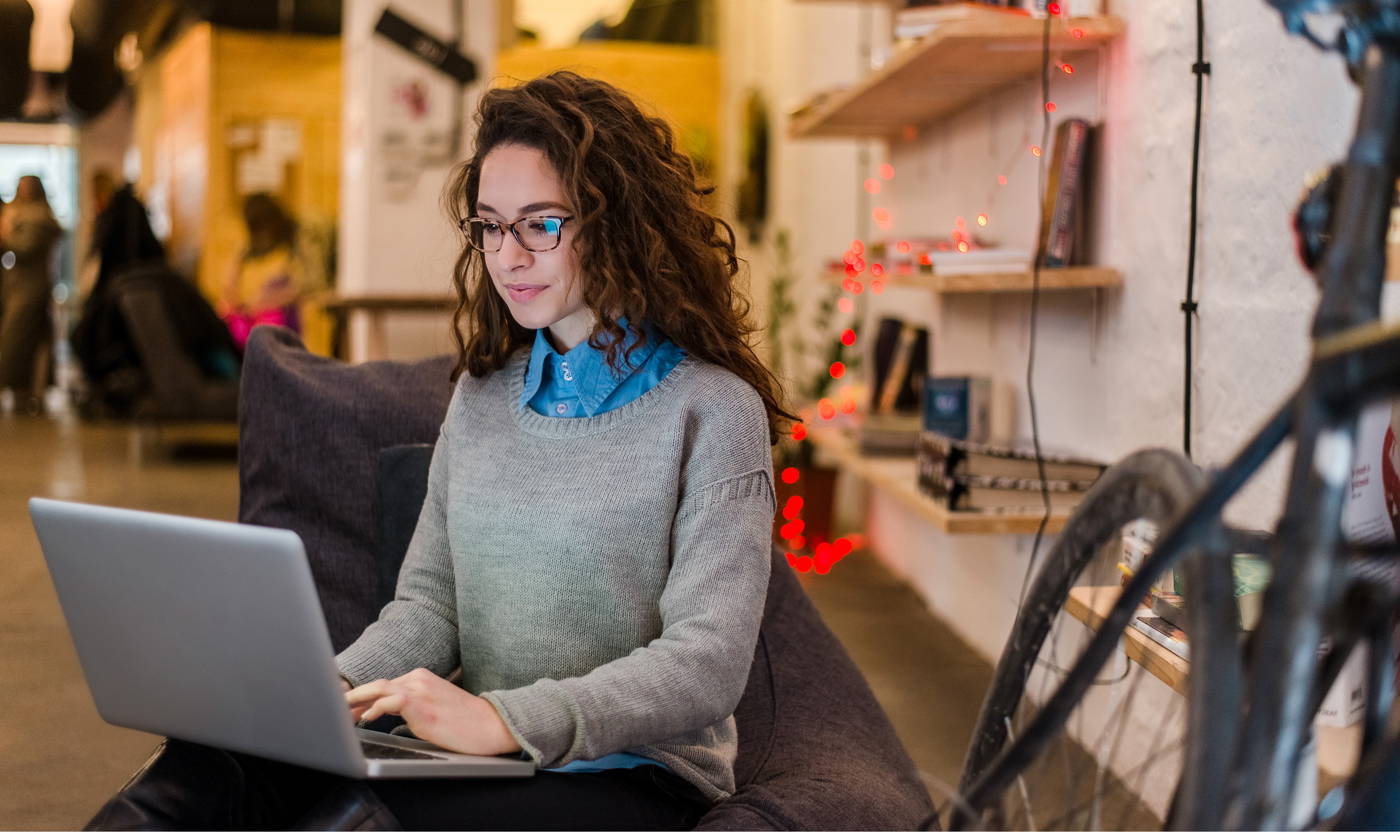 A person sitting on a couch using a computer