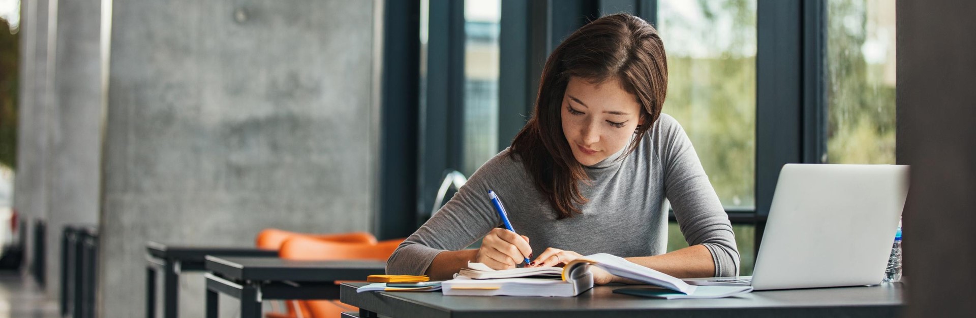 A person writing on a book