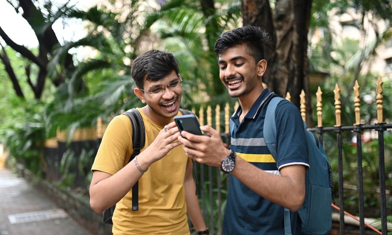 Two men looking at a phone