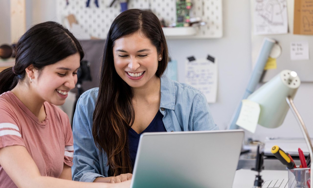 A couple of women looking at a computer