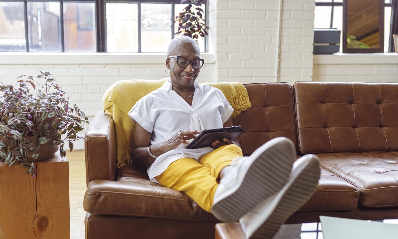 A person sitting on a couch using a tablet