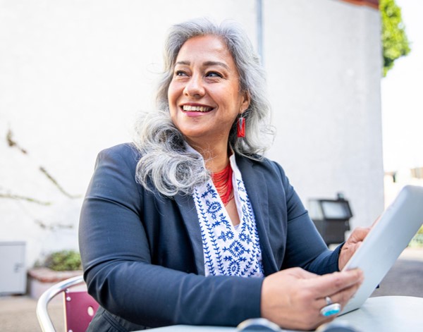 A person holding an object smiling in distance