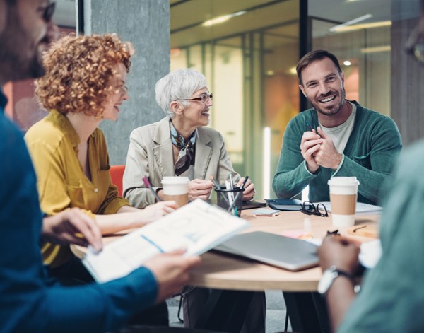 A group of people having coffee at a desk