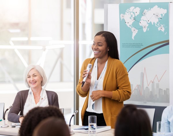 A women standing with a microphone