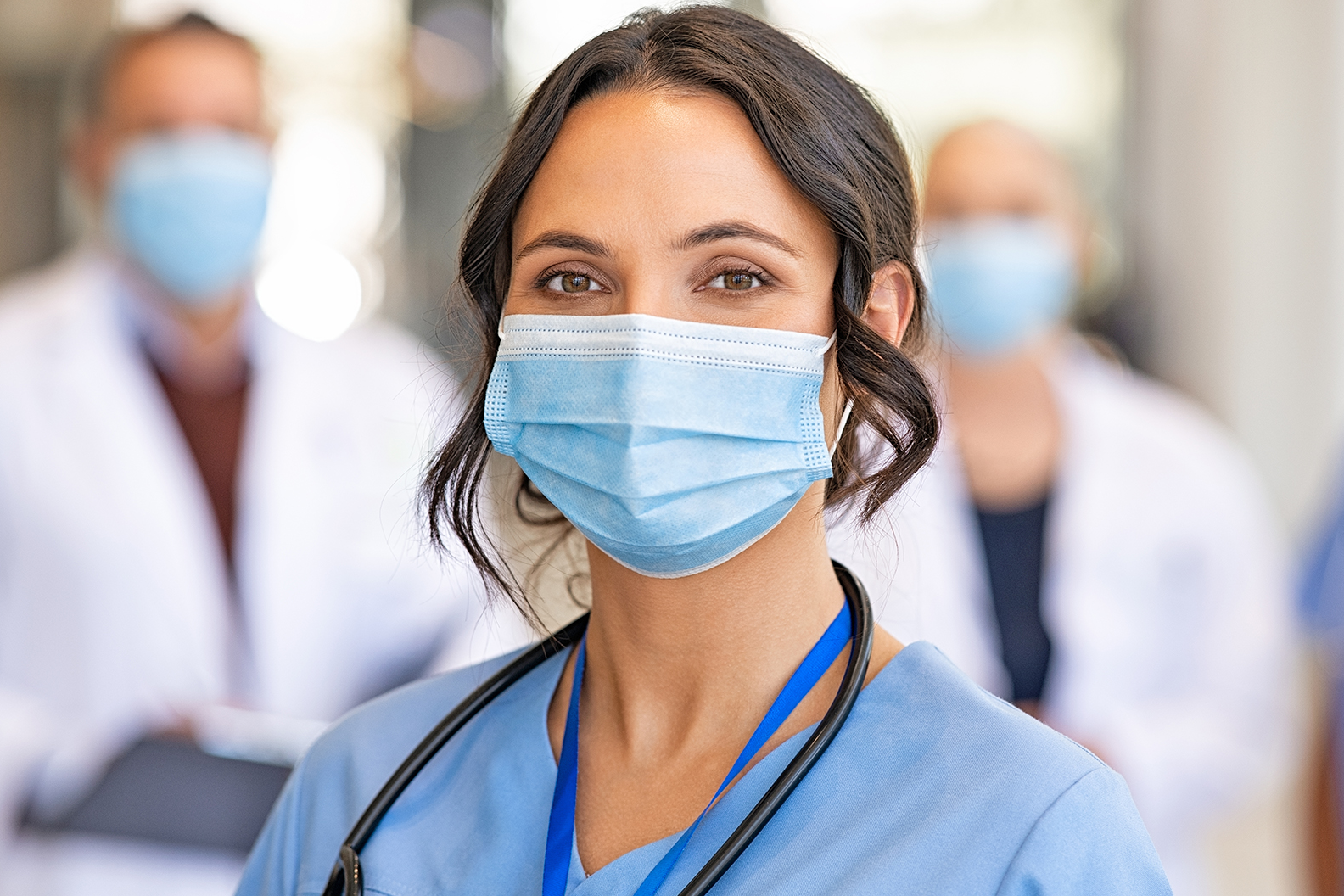 masked nurse in hallway