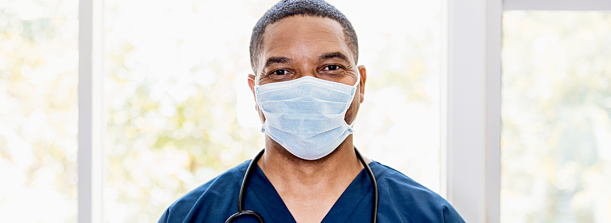 masked nurse in hospital hallway