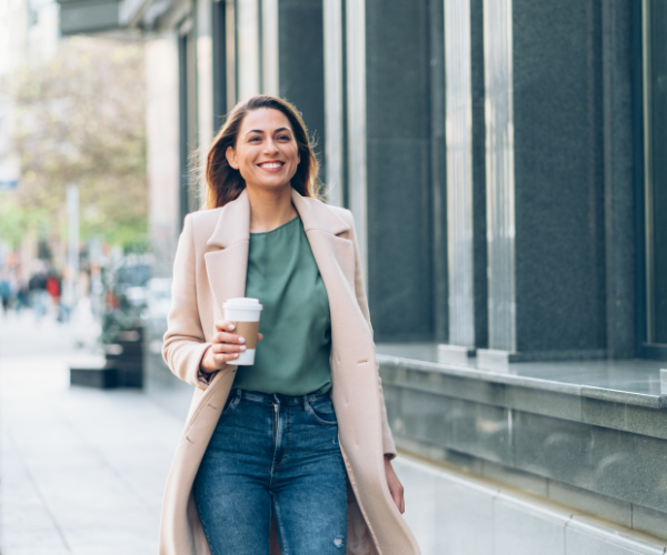 happy woman walking down street