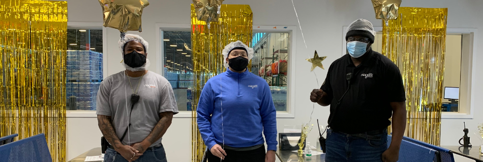 Niagara team members smiling in a gold-decorated room