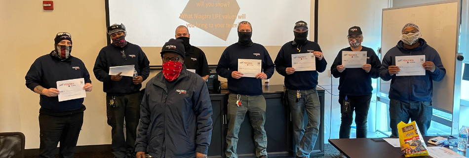 Photo of Niagara team members holding up their safety certifications