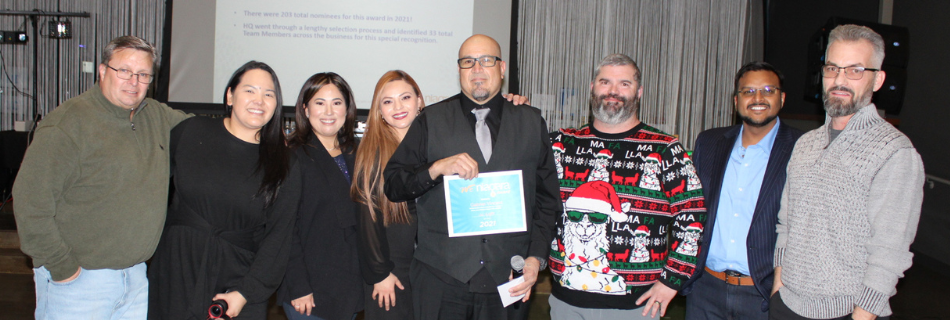 Team members smiling at their holiday party 