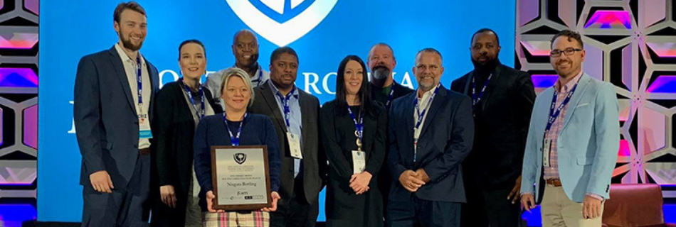 Photo of Niagara Team Members with an award plaque at an event