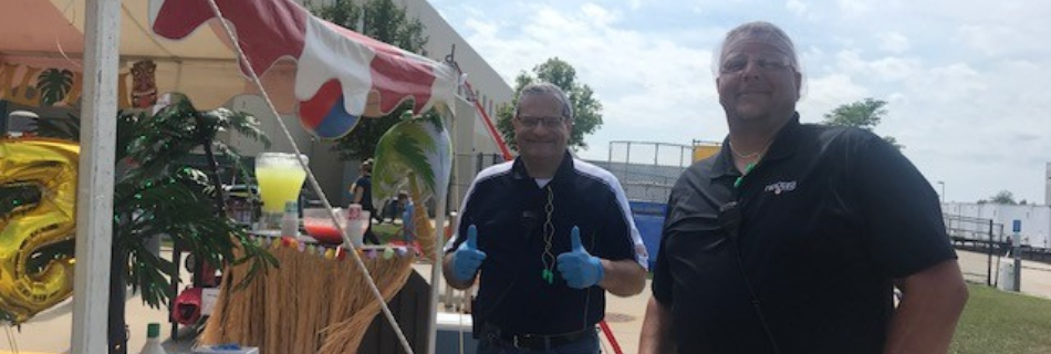Two men smiling at a Hawaiian luau