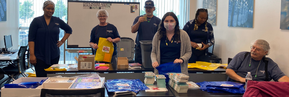 Men and women smiling and loading kits