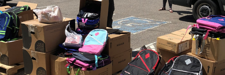 Photo of backpacks on top of/in boxes 