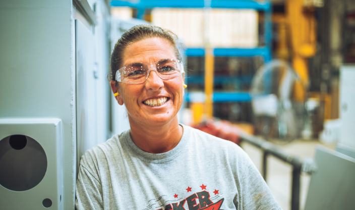 Female production worker in a grey t-shirt