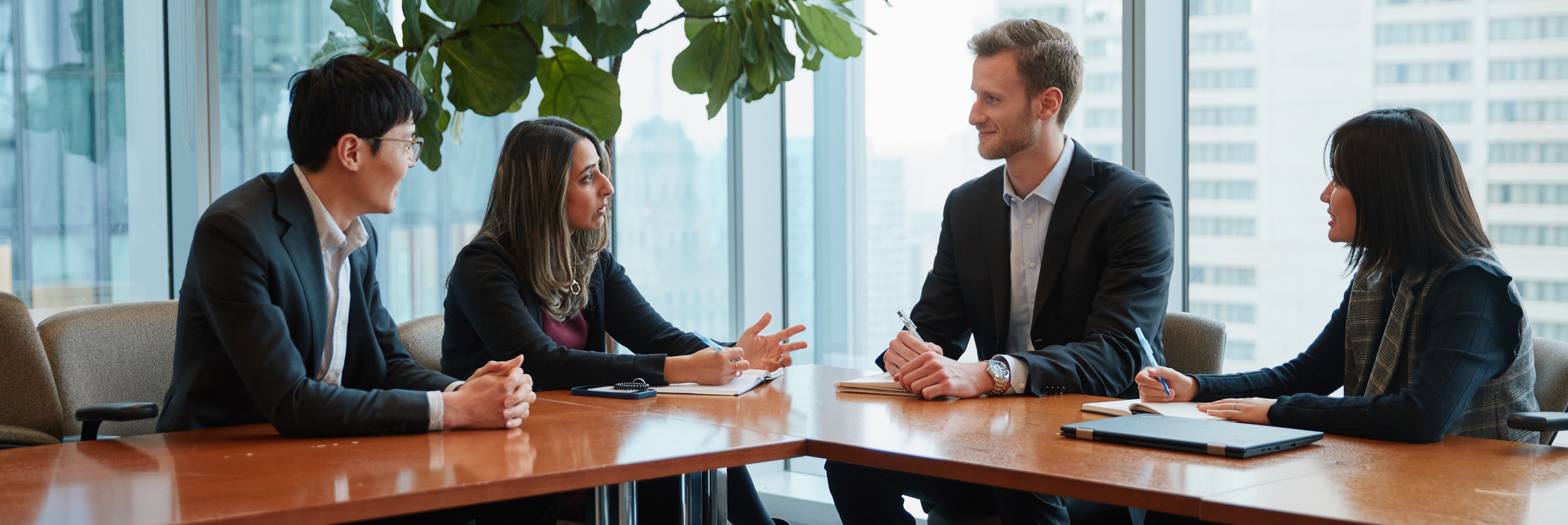 Men and women sitting at a table talking