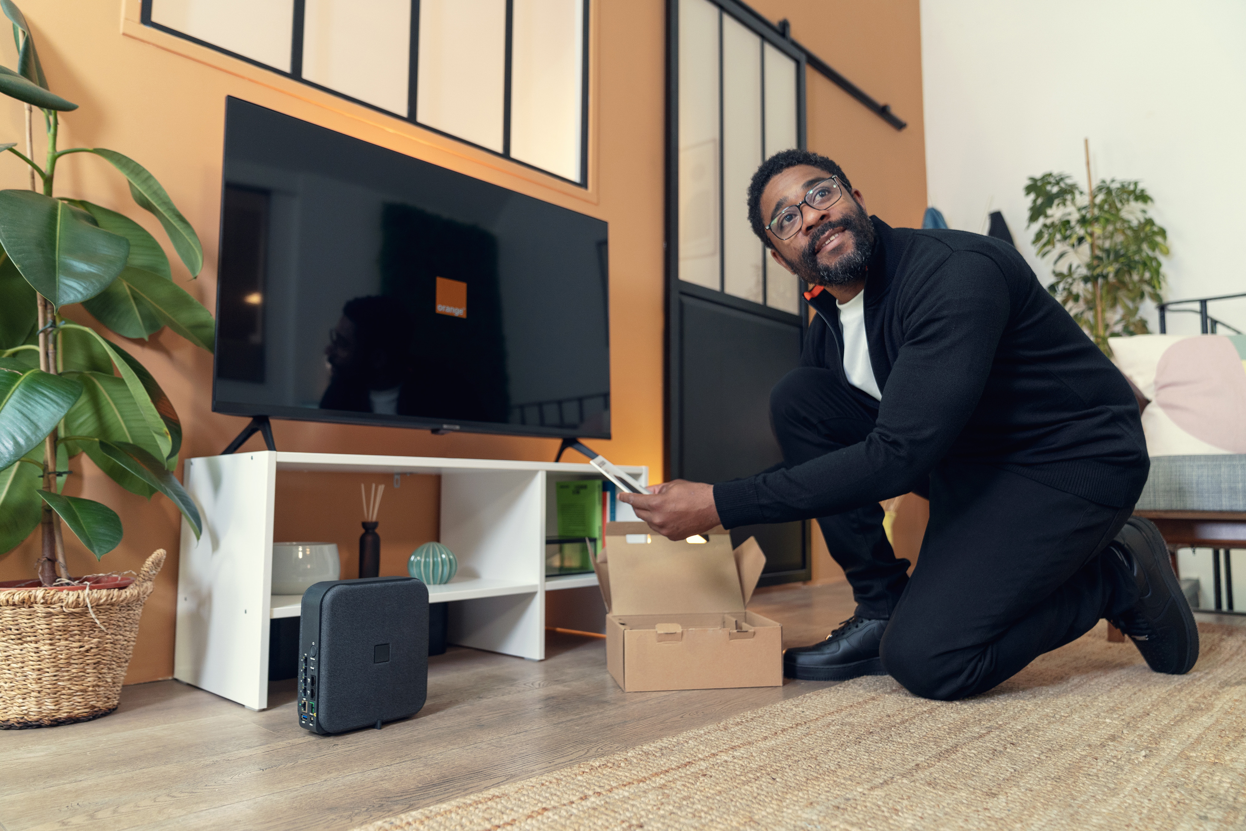 An Orange technician sets up the internet connection for a client.