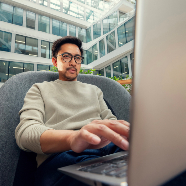 An Orange employee working at a desk