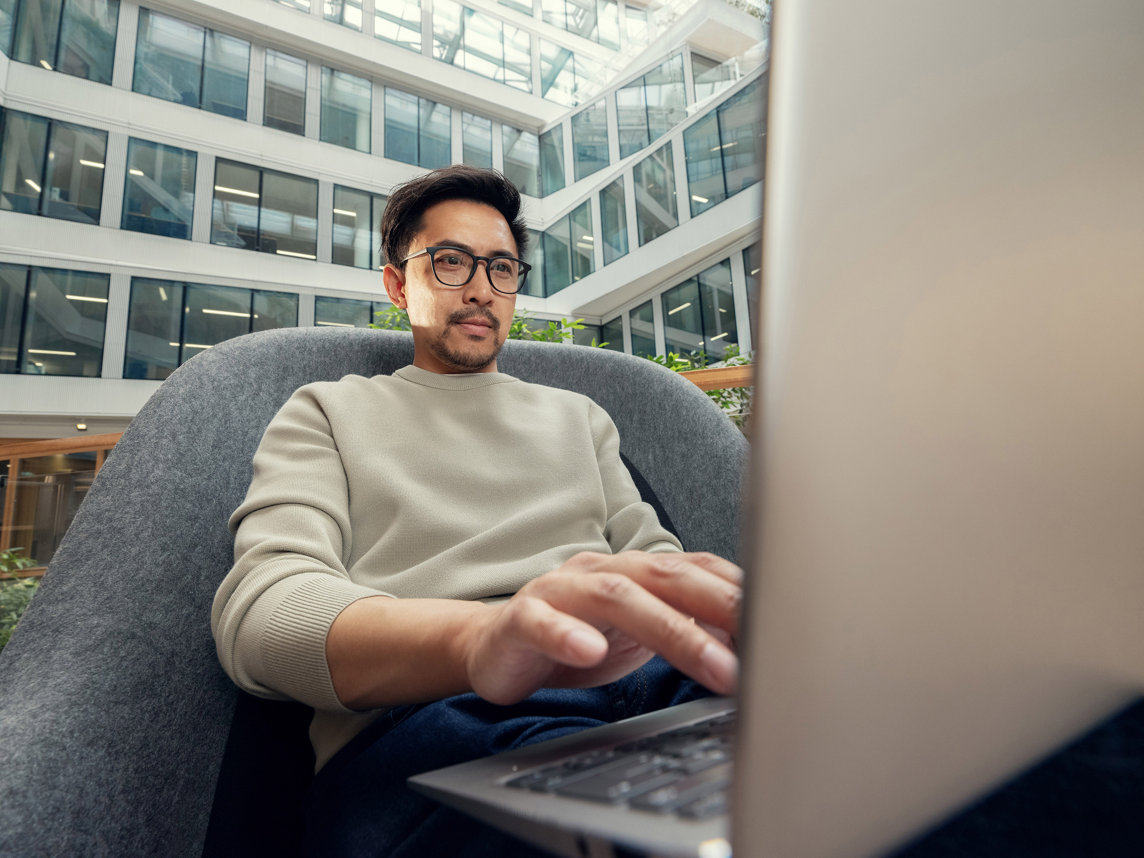 An Orange employee working at a desk