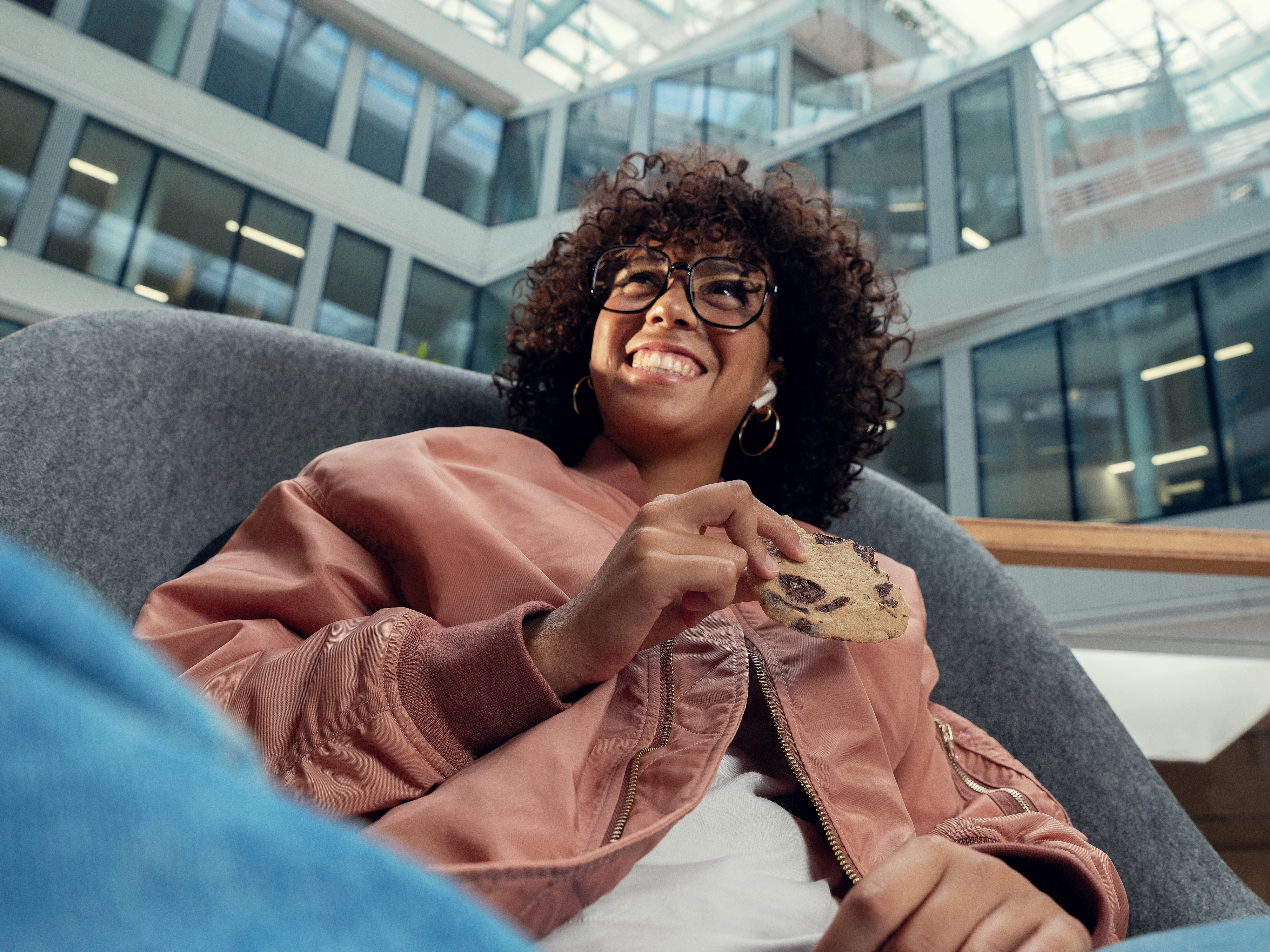 An Orange employee smiling in a relaxation area