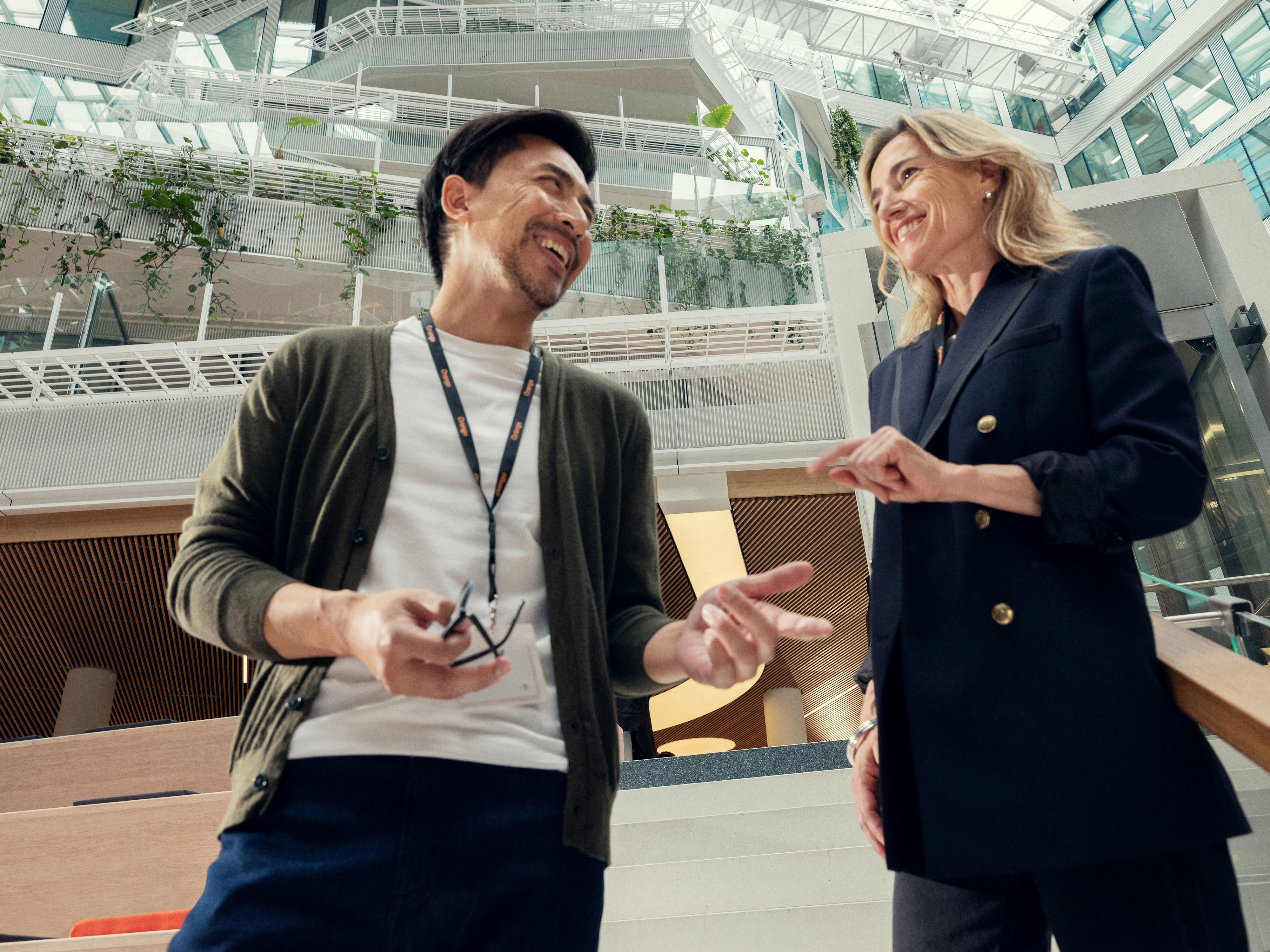 Two Orange employees talking in the office
