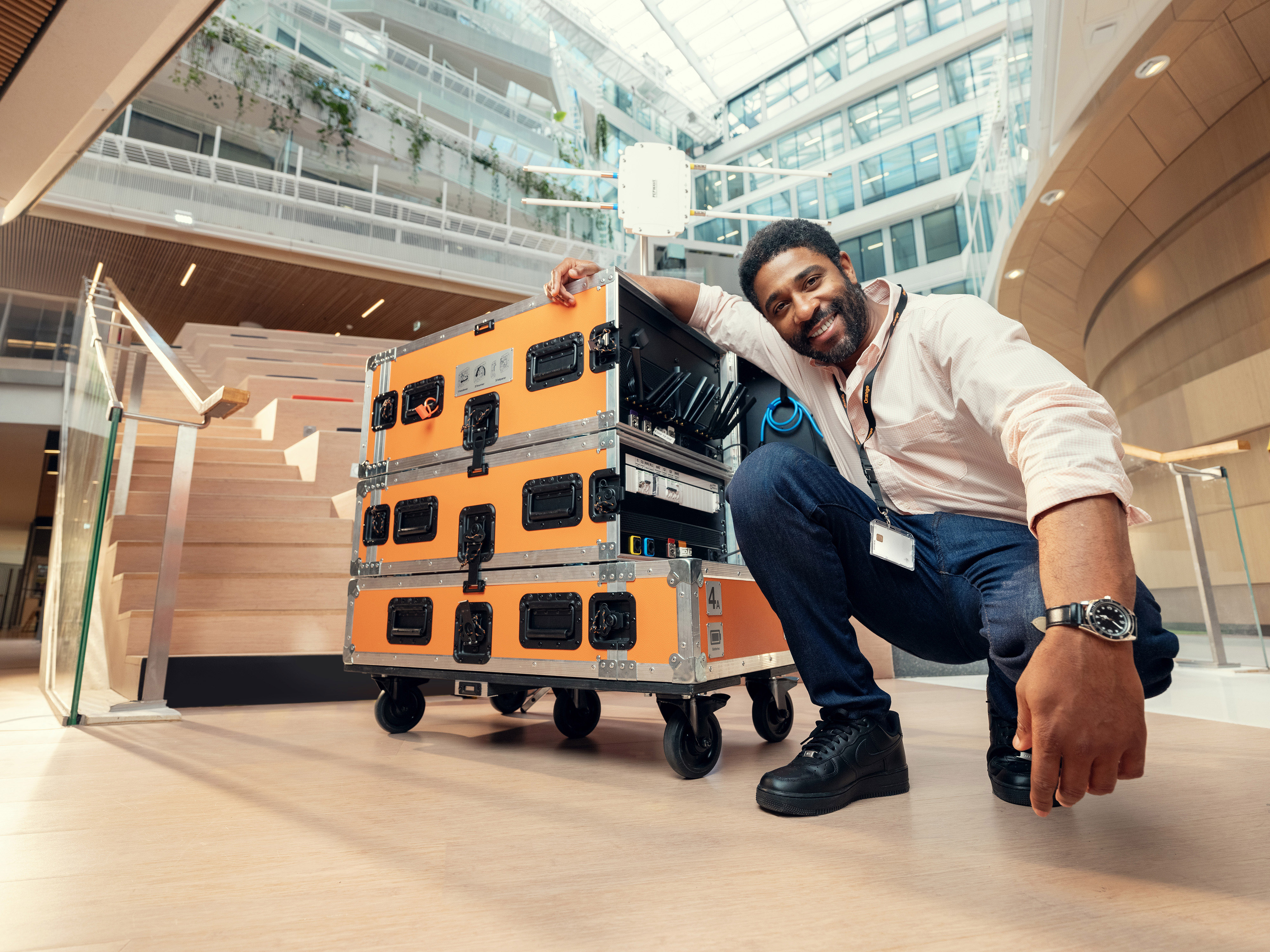 An employee smiling with a workstation