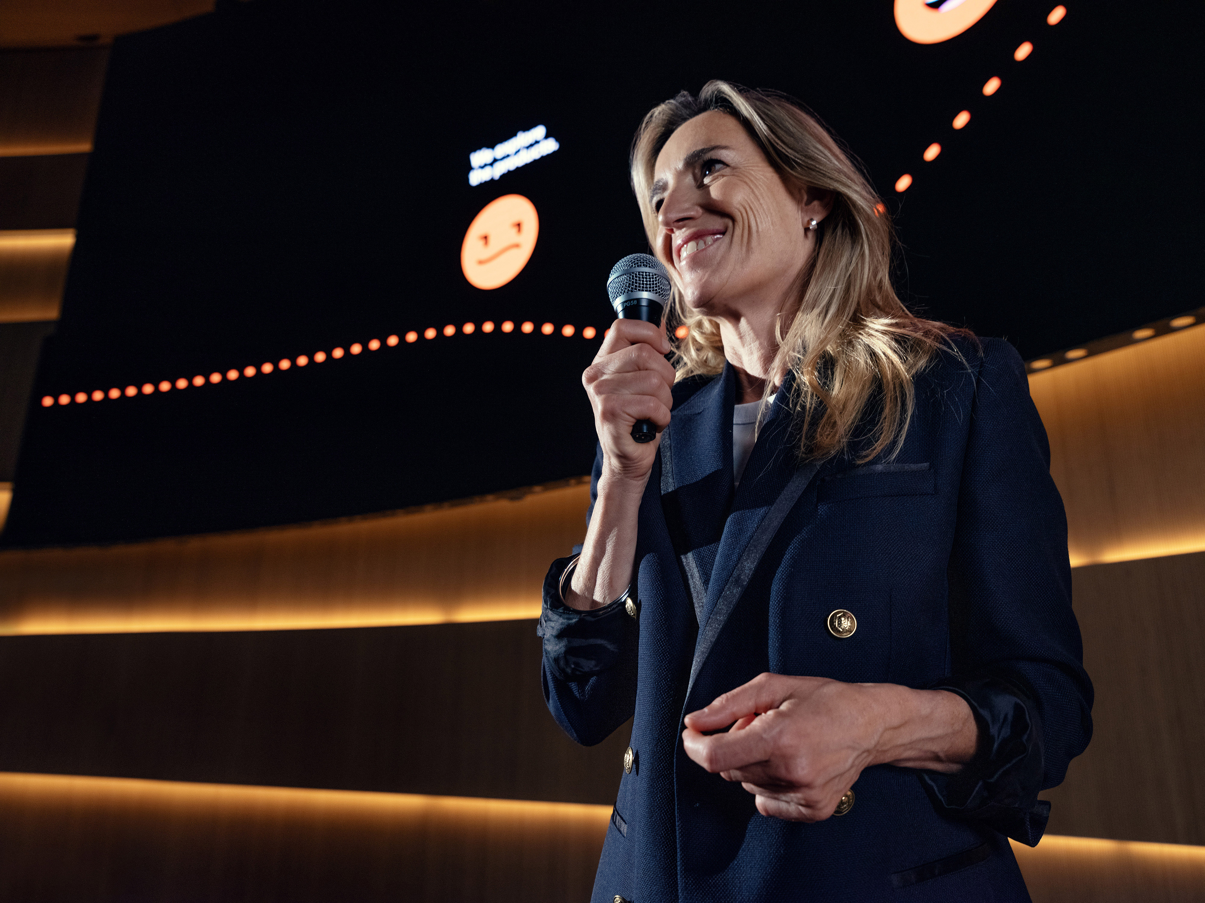 An Orange manager smiling during a conference