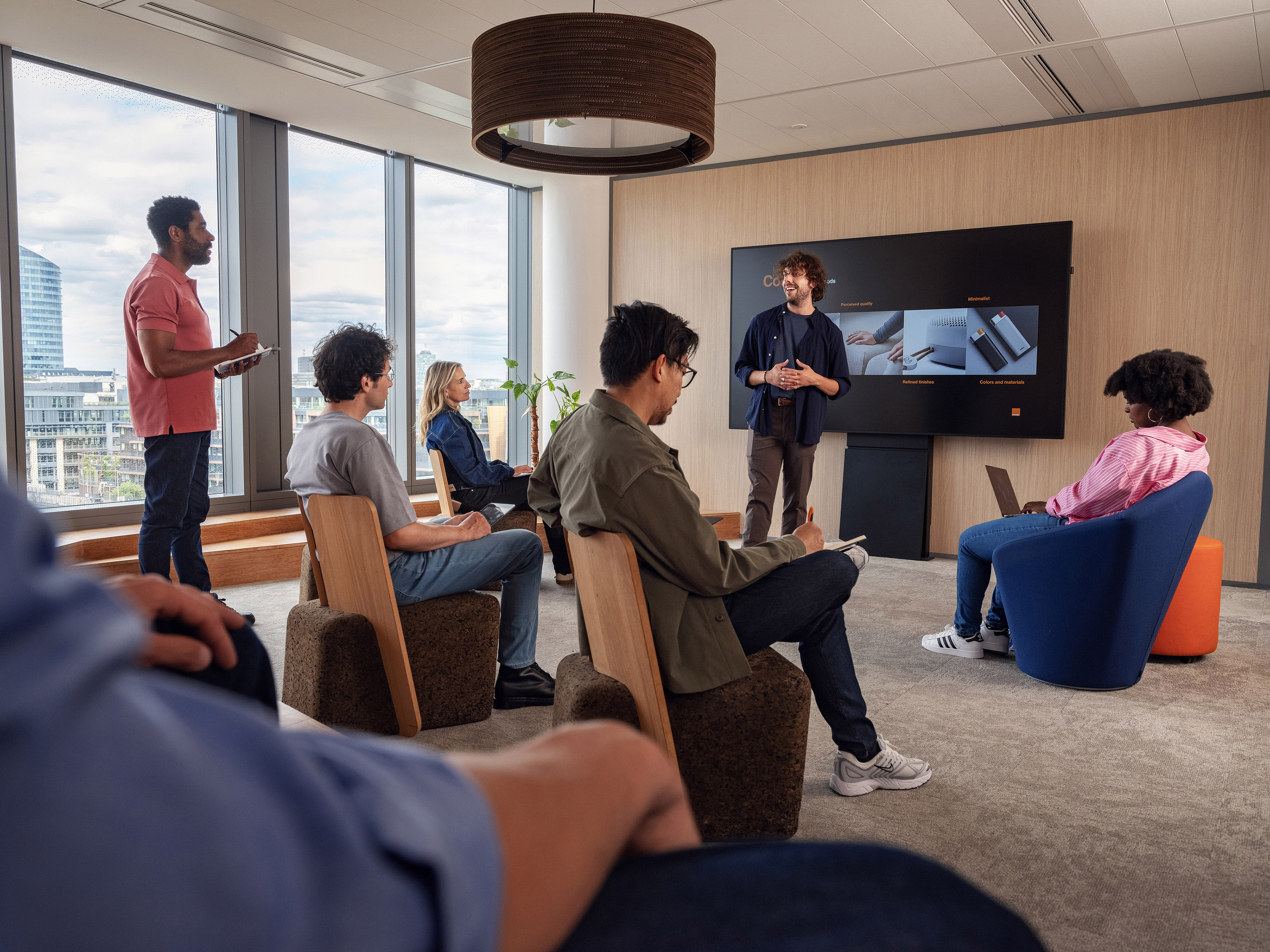 Orange colleagues enjoying a pleasant moment in a meeting.