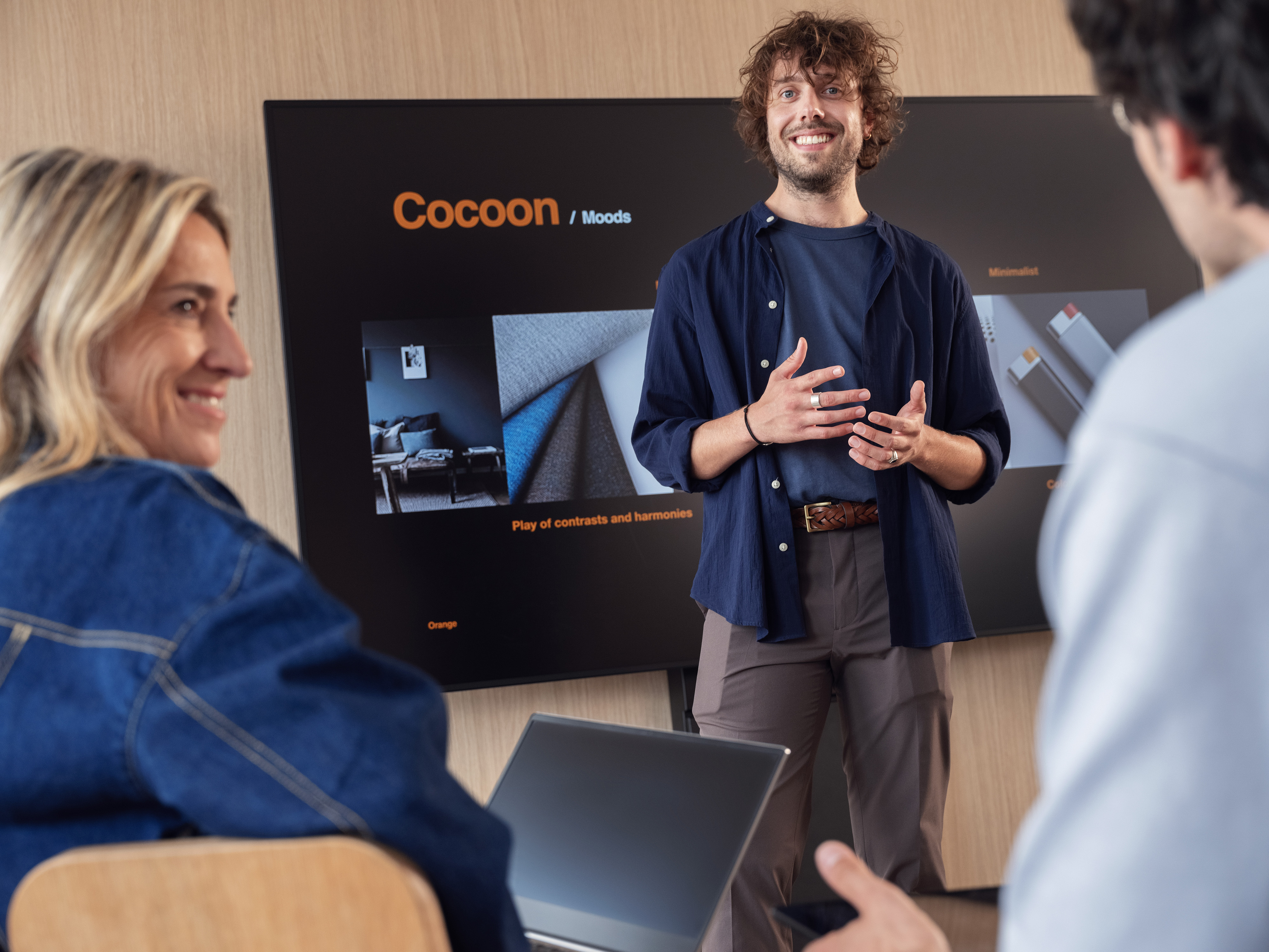 A group of Orange employees having a good time in a meeting.