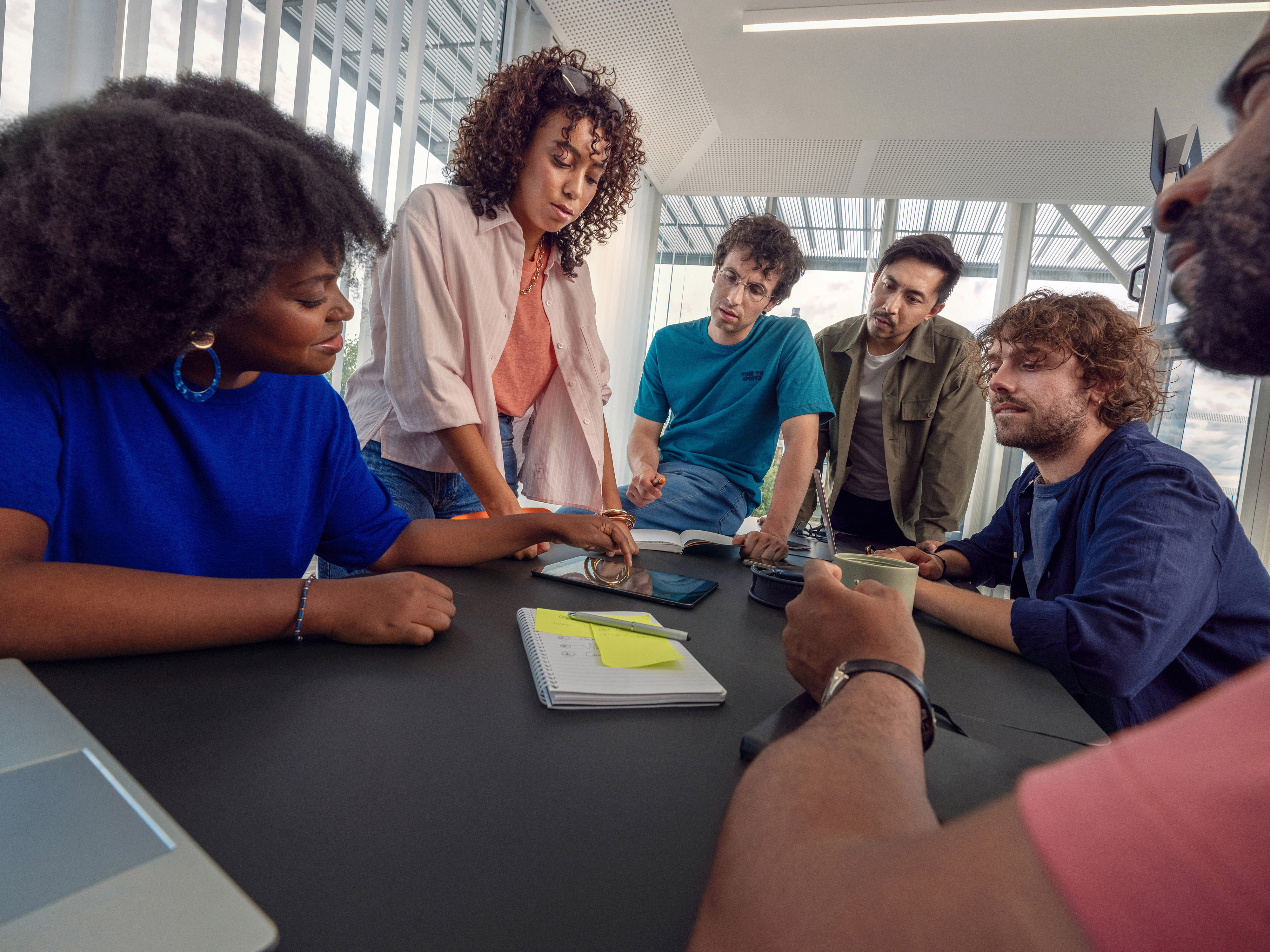 An Orange team sharing a pleasant moment in a meeting.