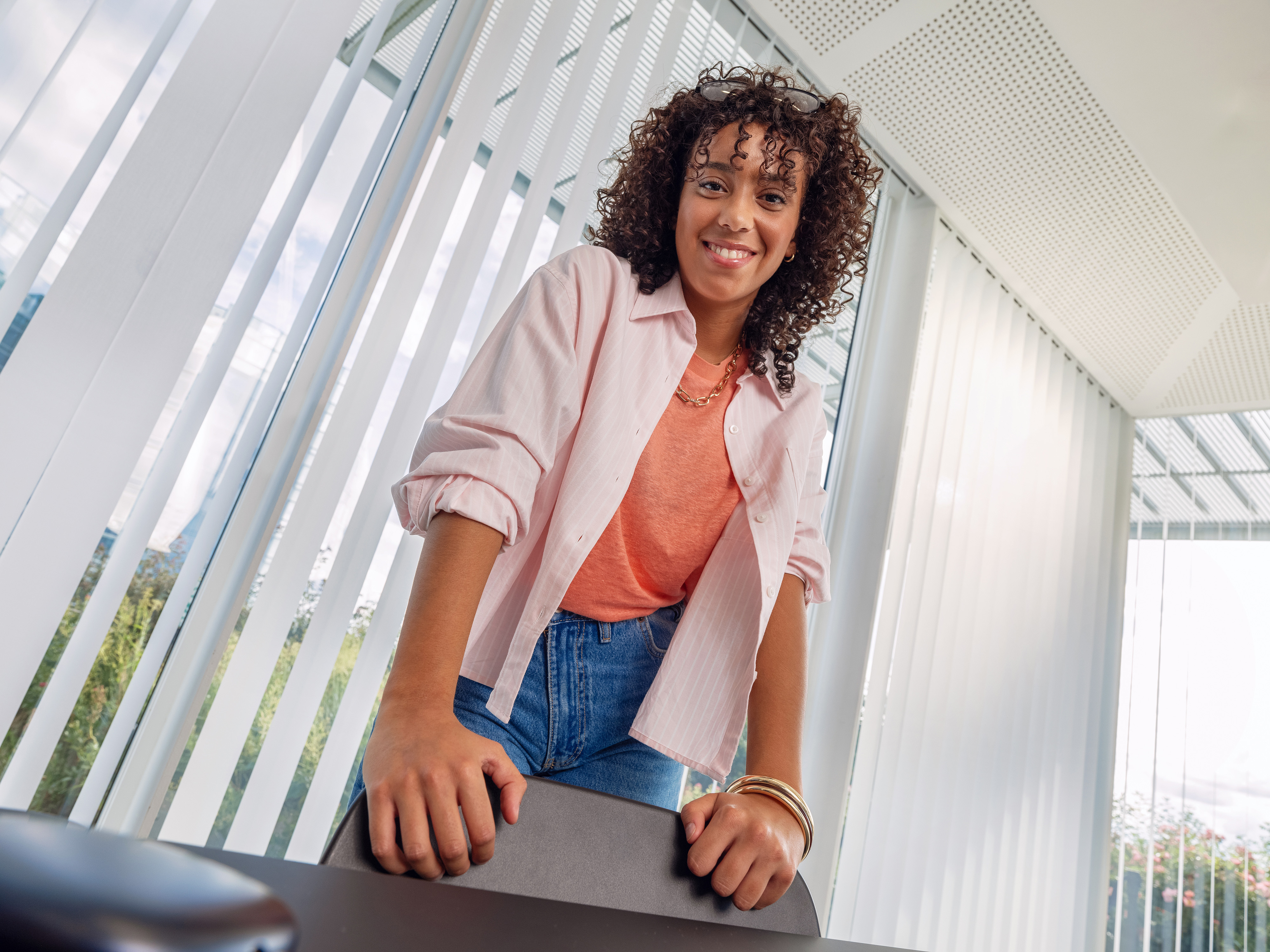 A young Orange employee smiling in a meeting room