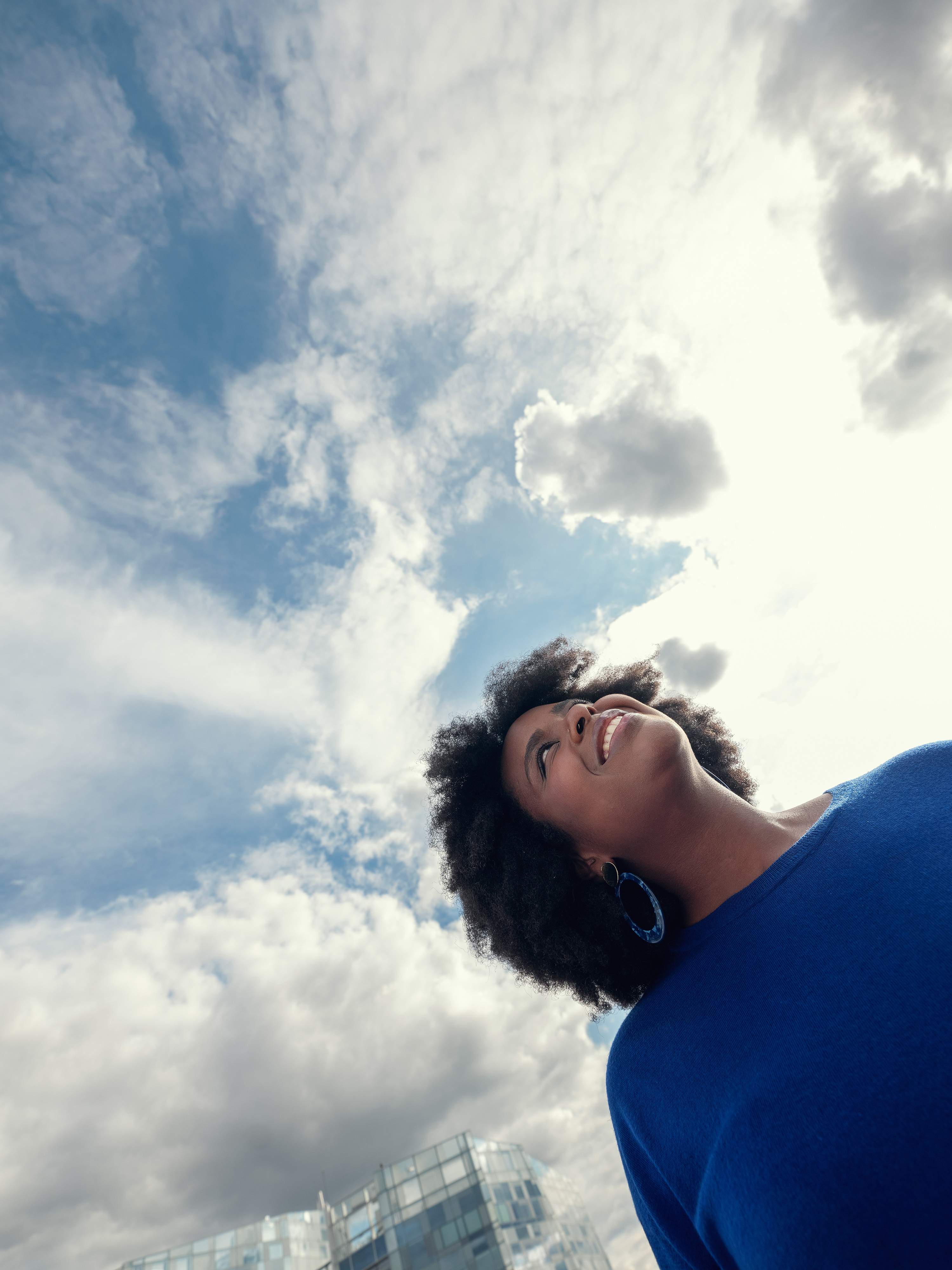 A woman looking at the sky with a smile
