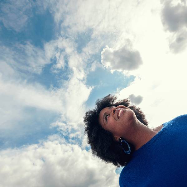 A woman looking at the sky with a smile