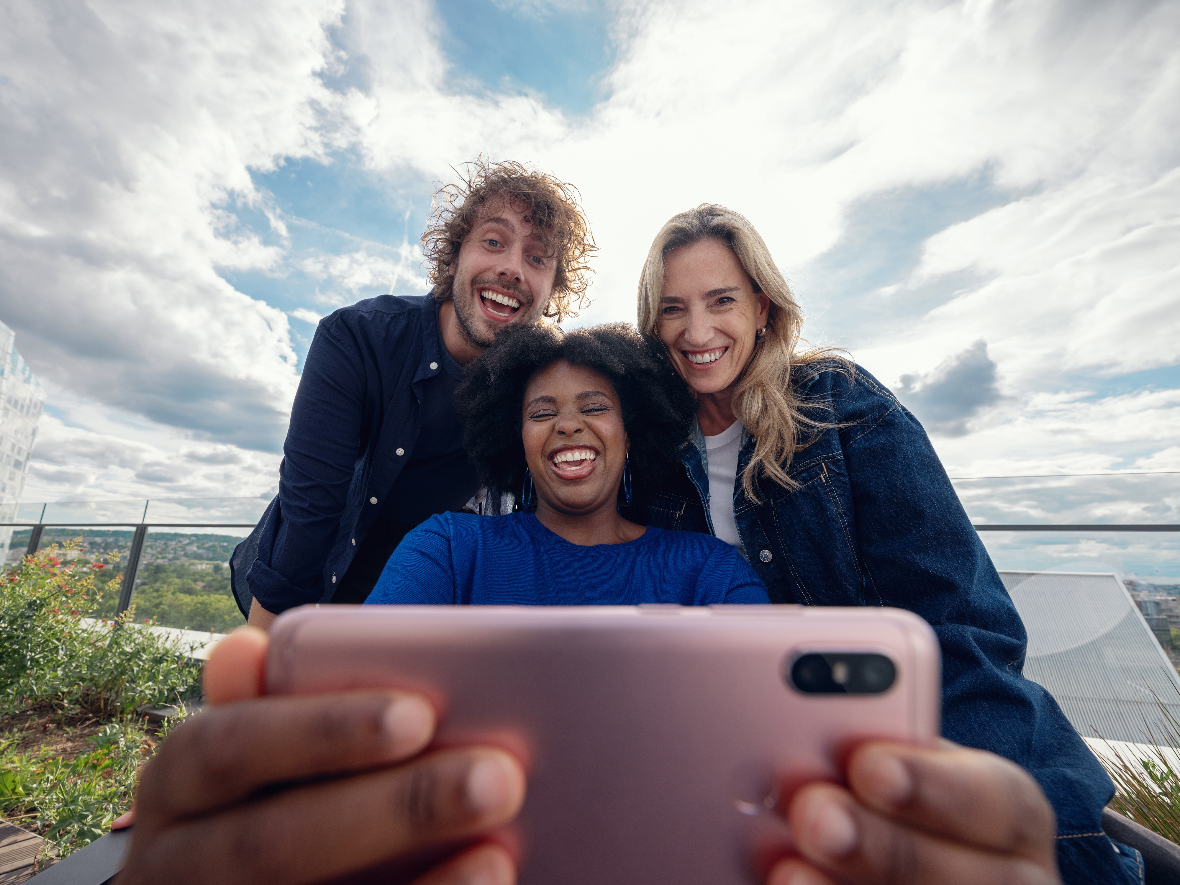 A group of Orange employees gathered around a phone.