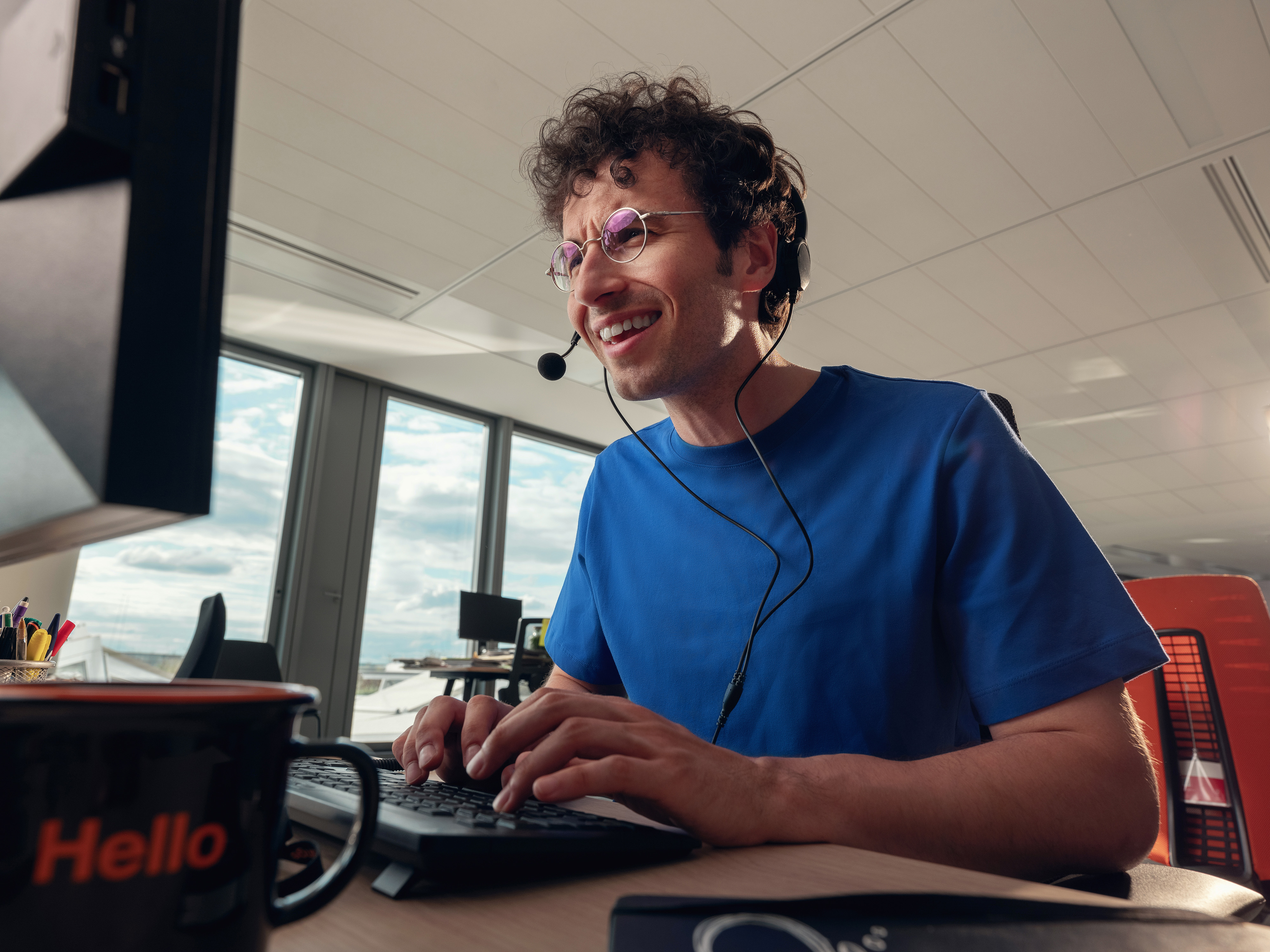 An Orange employee working on his computer