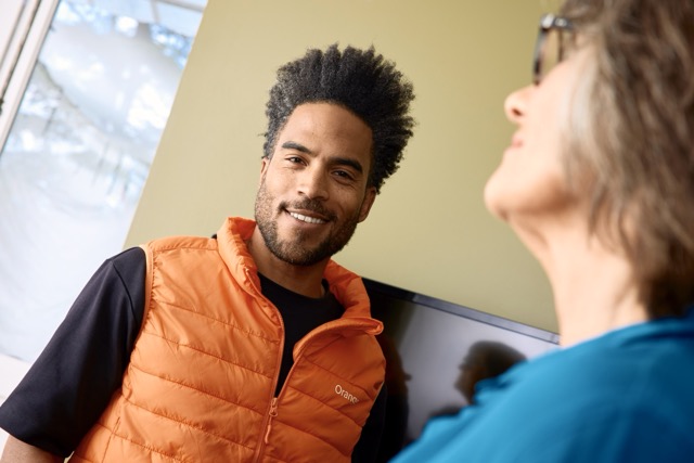 Orange technician installing network equipment