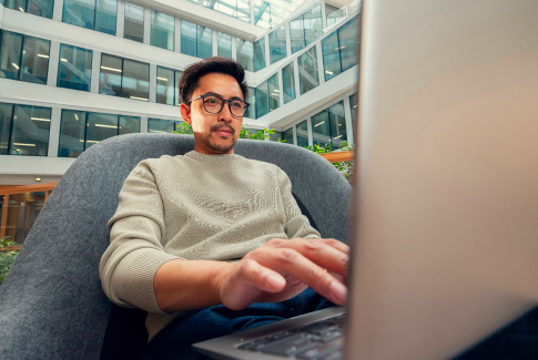 An Orange employee working at a desk